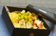 Holiday Cheese Box with four premium cheeses, crackers, dates, and grapes for festive celebrations