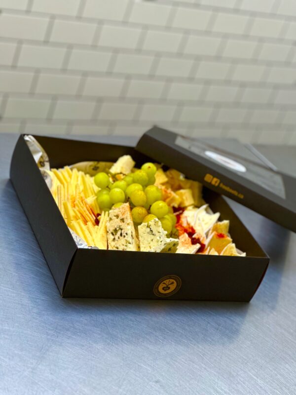 Holiday Cheese Box with four premium cheeses, crackers, dates, and grapes for festive celebrations